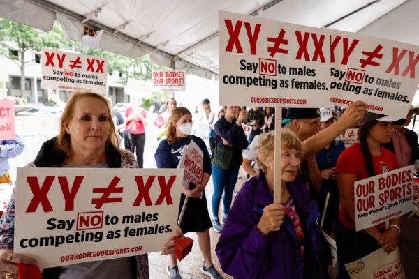 Demonstrators listen to the speaking program during an "Our Bodies, Our Sports" rally for the 50th anniversary of Title IX at Freedom Plaza in Washington on June 23, 2022. (Anna Moneymaker/Getty Images)