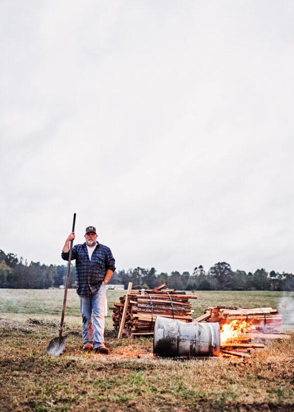 Whole-hog barbecue requires a feeder fire to provide a steady supply of hot coals. Martin’s method of choice is a burn barrel. (Andrew Thomas Lee)