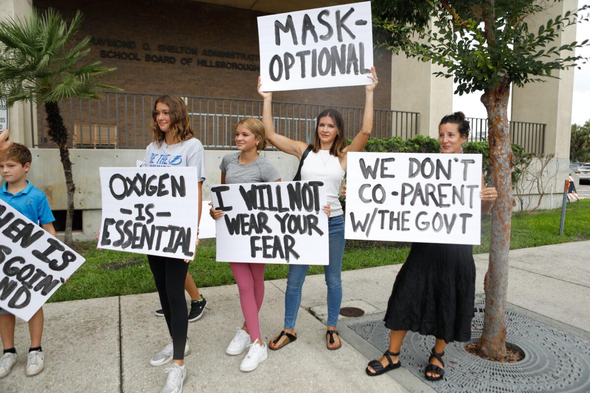 Families protest mask mandates before a Schools Board meeting in Tampa, Fla., on July 27, 2021. (Octavio Jones/Getty Images)
