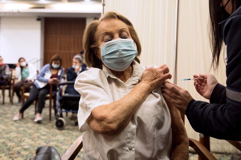 A resident receives a fourth dose of the coronavirus vaccine at a nursing home after Israel approved it for people over 60 in Tel Mond, Israel, on Jan. 6, 2022. (Amir Levy/Getty Images)