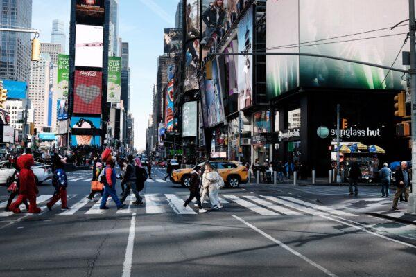 People walk through Times Square in New York on March 11, 2022. (Spencer Platt/Getty Images)