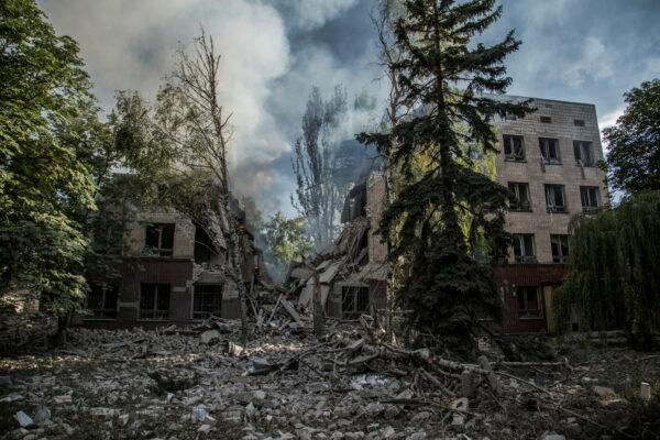 Smoke rises over the remains of a building destroyed by a military strike in Lysychansk, Luhansk region, Ukraine, on June 17, 2022. (Oleksandr Ratushniak/Reuters)