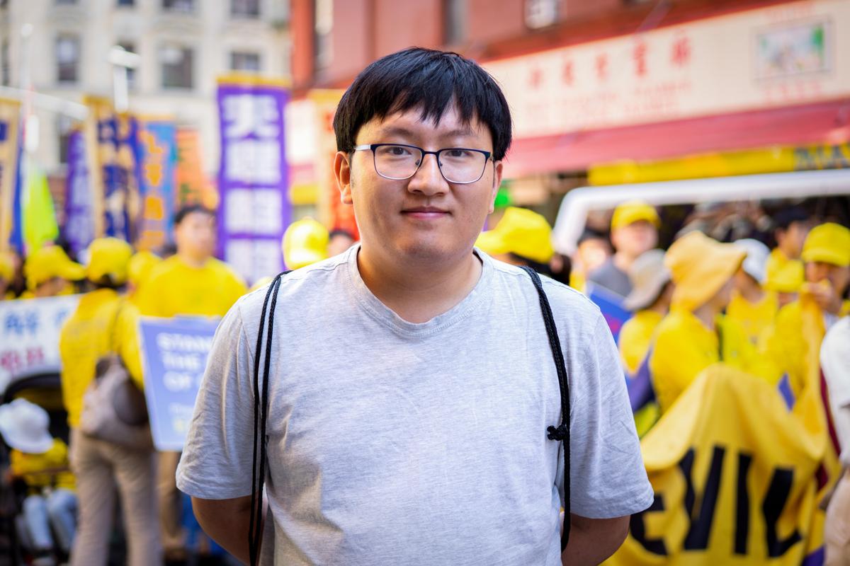 Falun Gong practitioner Yan Pengfei takes part in a parade to commemorate the 23rd anniversary of the persecution of the spiritual discipline in China, in New York's Chinatown on July 10, 2022. (Chung I Ho/The Epoch Times)