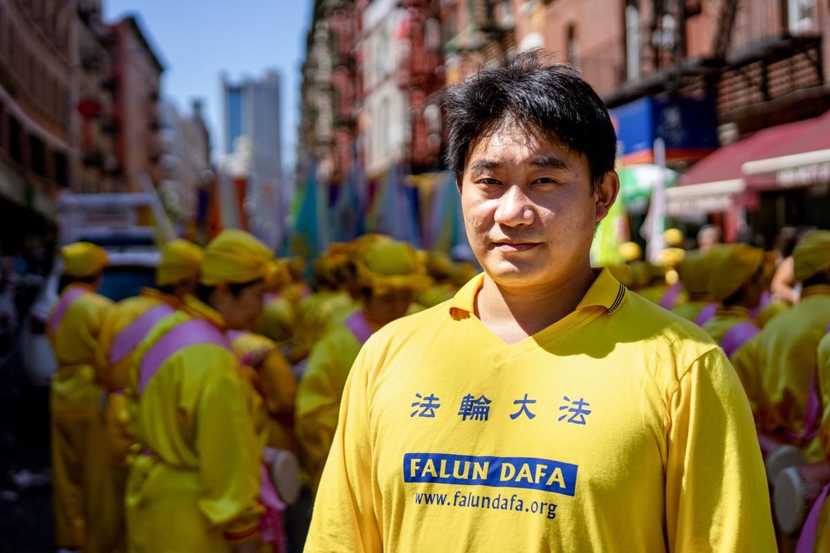 Falun Gong practitioner Cheng Song takes part in a parade to commemorate the 23rd anniversary of the persecution of the spiritual discipline in China, in New York's Chinatown on July 10, 2022. (Chung I Ho/The Epoch Times)