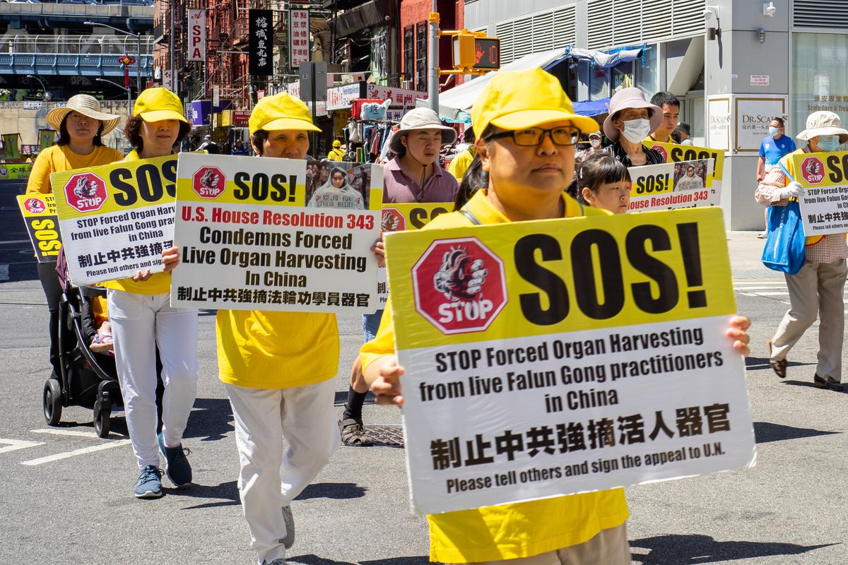 Falun Gong practitioners take part in a parade to commemorate the 23rd anniversary of the persecution of the spiritual discipline in China, in New York's Chinatown on July 10, 2022. (Chung I Ho/The Epoch Times)