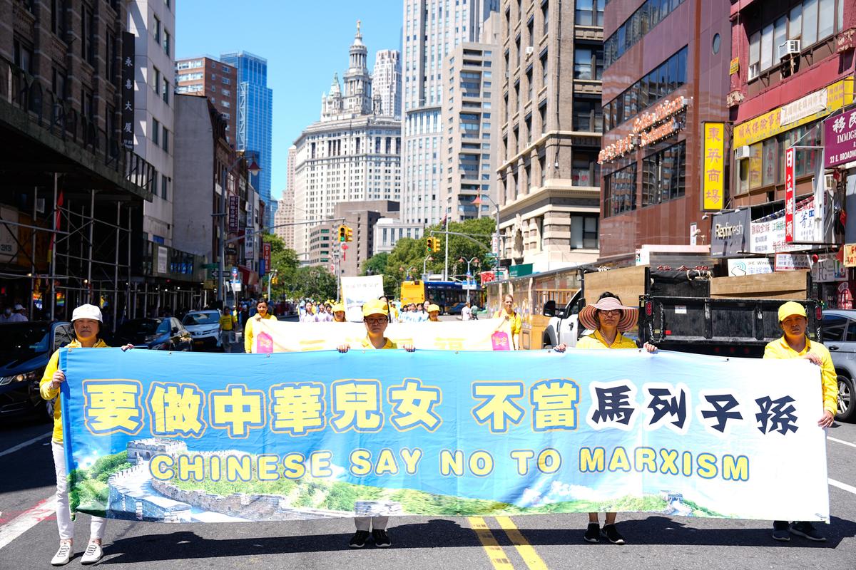 Falun Gong practitioners take part in a parade to commemorate the 23rd anniversary of the persecution of the spiritual discipline in China, in New York's Chinatown on July 10, 2022. (Larry Dye/The Epoch Times)