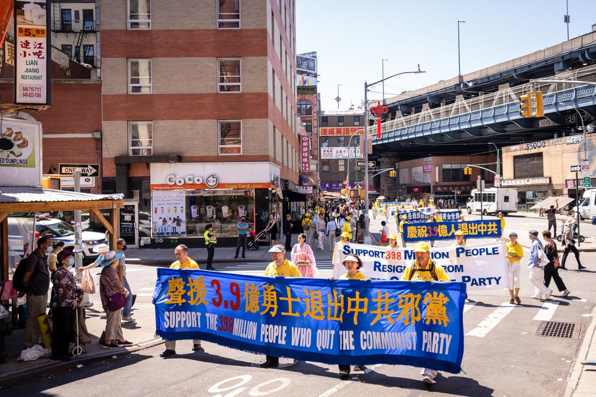 Falun Gong practitioners take part in a parade to commemorate the 23rd anniversary of the persecution of the spiritual discipline in China, in New York's Chinatown on July 10, 2022. (Samira Bouaou/The Epoch Times)
