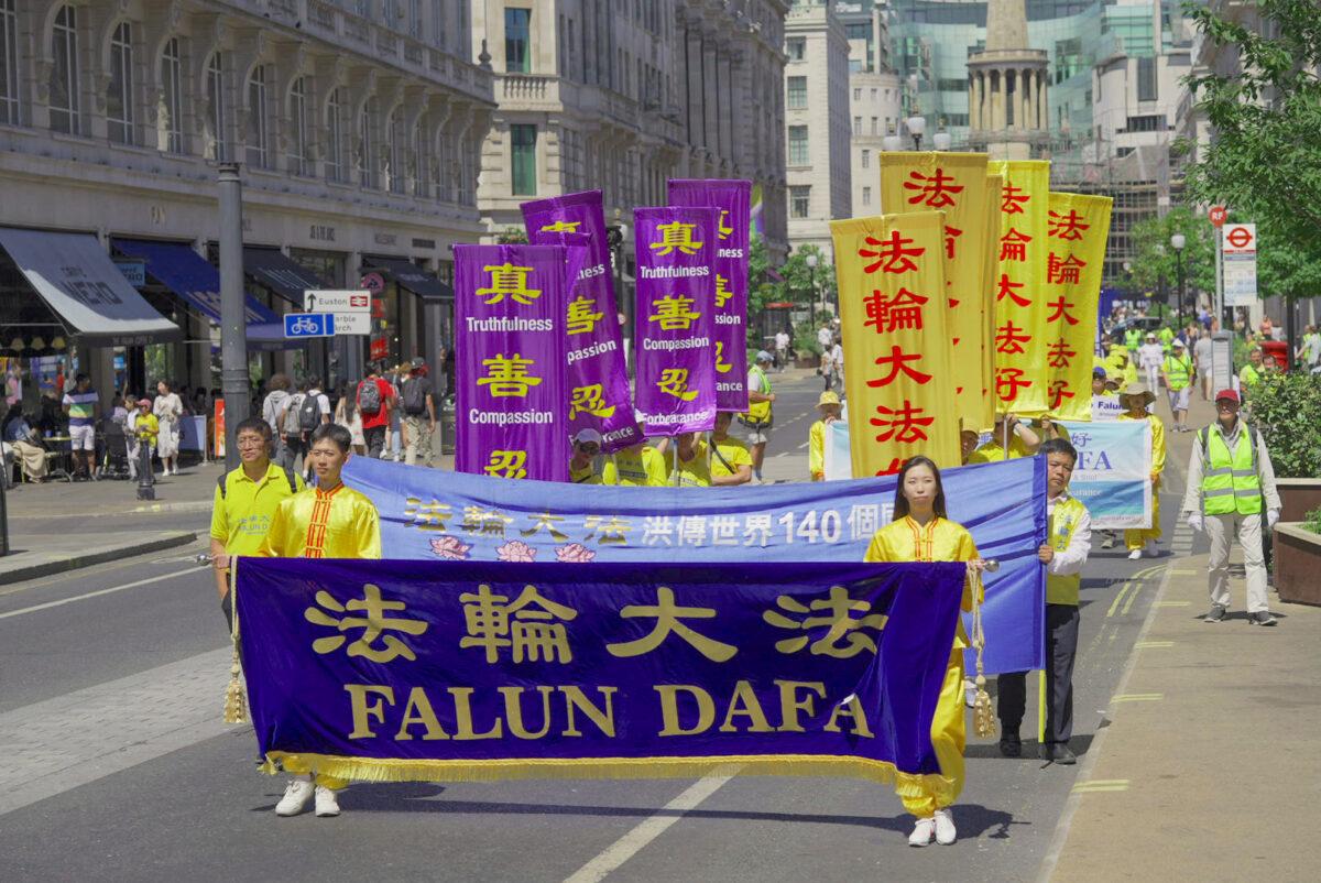 Falun Gong practitioners march to highlight the 23rd year of persecution in China against the spiritual discipline, in London, UK, on July 16, 2022. (Yanning Qi/The Epoch Times)