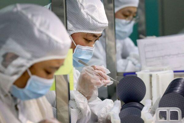 Employees make chips at a factory of Jiejie Semiconductor Company in Nantong, Jiangsu Province, China, on March 17, 2021. (STR/AFP via Getty Images)