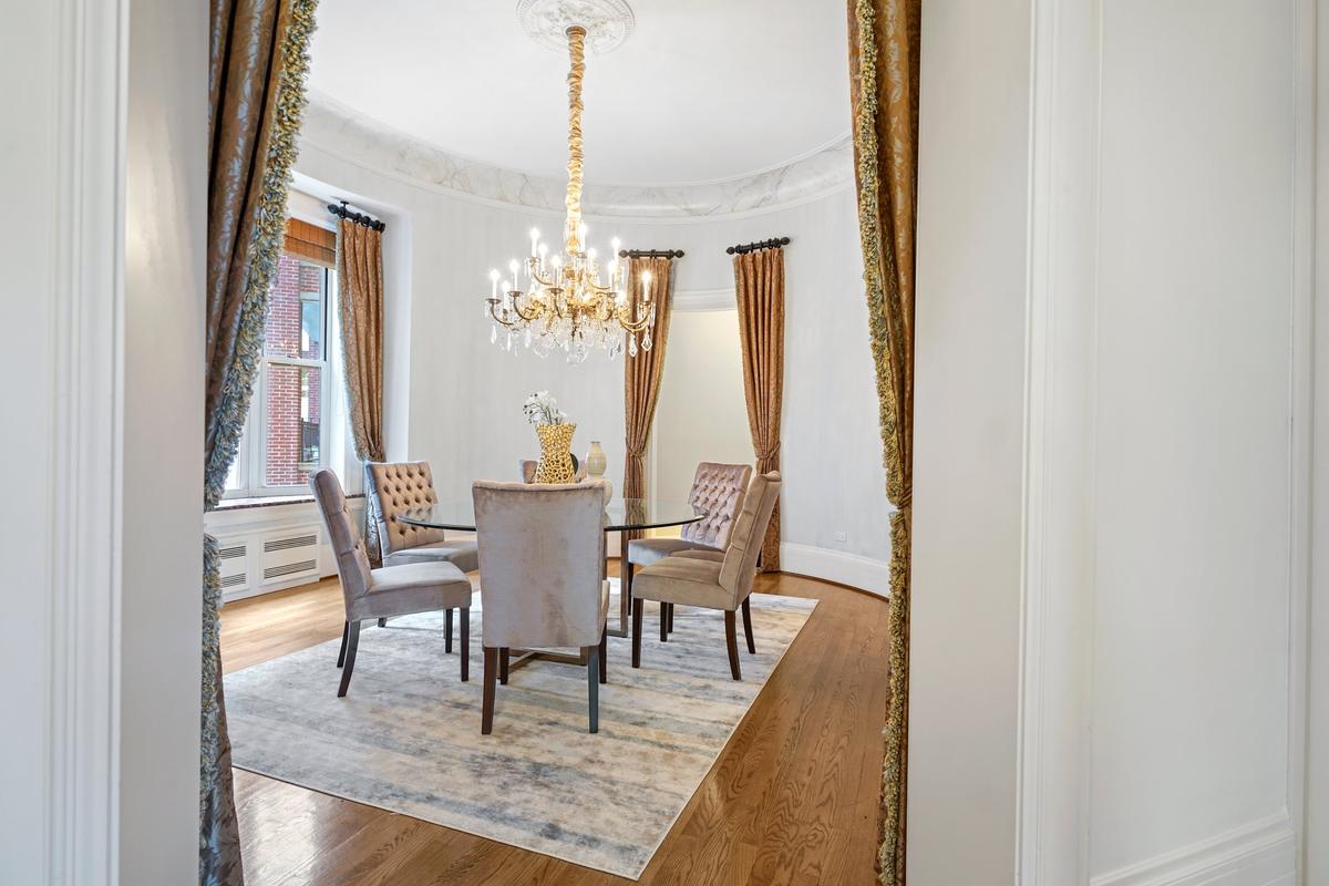 Each of the sumptuous rooms features period millwork and other fine-crafted accents. The 306-square-foot round dining room looks out over a classic Chicago cityscape. (Courtesy of Americorp Ltd-Laricy)
