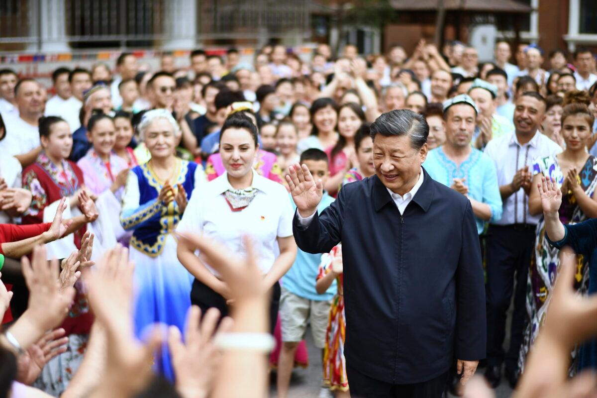 In this photo released by China's Xinhua News Agency, Chinese leader Xi Jinping (C) visits the community of Guyuanxiang in the Tianshan District in Urumqi in northwestern China's Xinjiang Uyghur Autonomous Region, on July 13, 2022. (Yan Yan/Xinhua via AP)