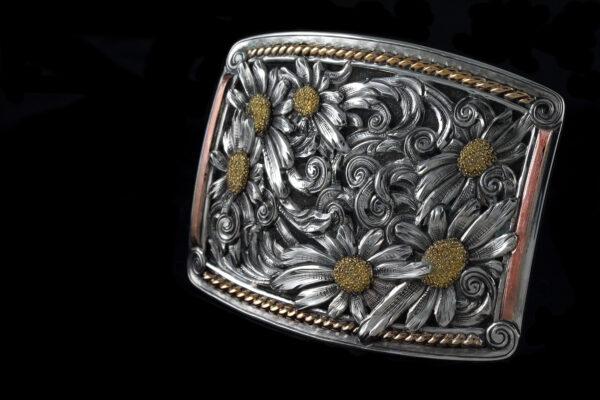 Silversmith Scott Hardy’s entry for the 2022 Traditional Cowboy Arts Exhibition & Sale at the National Cowboy & Western Heritage Museum in Oklahoma City. Buckle, 2022, by Scott Hardy. Sterling silver buckle with sterling silver flower and scroll overlays, 14-karat green-gold flower centers, 14-karat red-gold trim, and 14-karat gold twist rope. (Leslie Hardy)