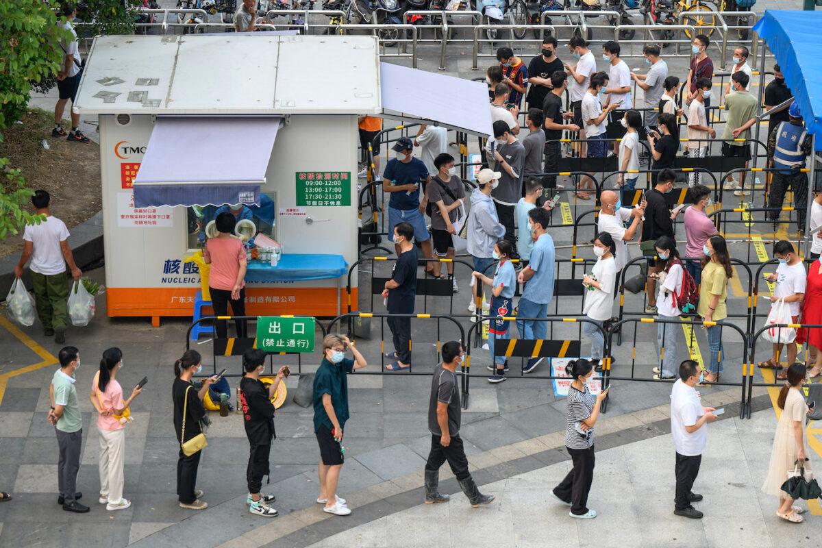 Residents wait in line to undergo PCR testing for COVID-19 at a swab collection site in Guangzhou, in China's southern Guangdong Province in August 2022. (STR/AFP via Getty Images)