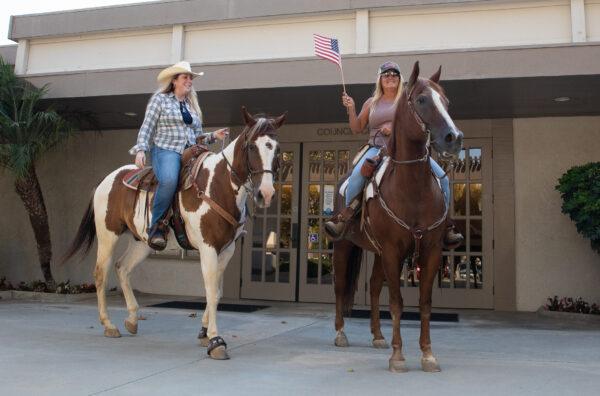 Horse owners post in front of City Hall in Yorba Linda, Calif., on Aug. 2, 2022. (John Fredricks/The Epoch Times)