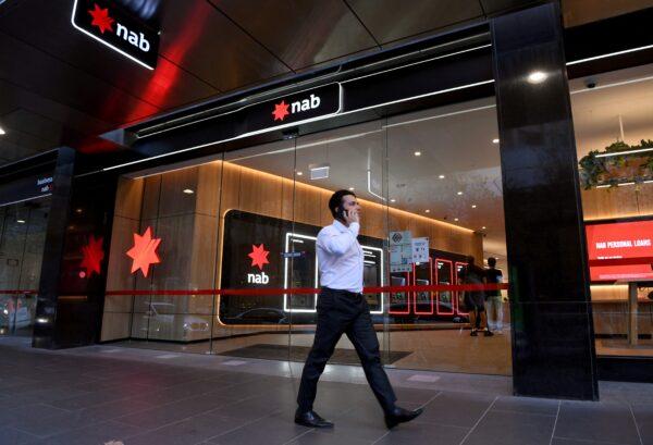 A man walks past a branch of the National Australia Bank in Melbourne, Australia, on May 6, 2021. (William West/AFP via Getty Images)