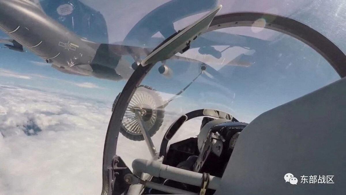 An air force aircraft under the Eastern Theatre Command of the Chinese army gets refueled mid-air during military exercises in the waters around Taiwan on Aug. 4, 2022, in this screengrab from video. (Eastern Theatre Command/Handout via Reuters)