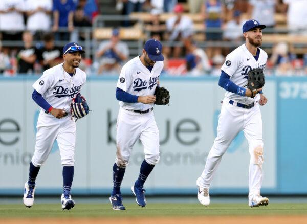 (R-L) Cody Bellinger #35, Chris Taylor #3 and Mookie Betts #50 of the Los Angeles Dodgers react as they leave the field after a 4-0 win over the San Diego Padres at Dodger Stadium in Los Angeles, on August 07, 2022. (Harry How/Getty Images)