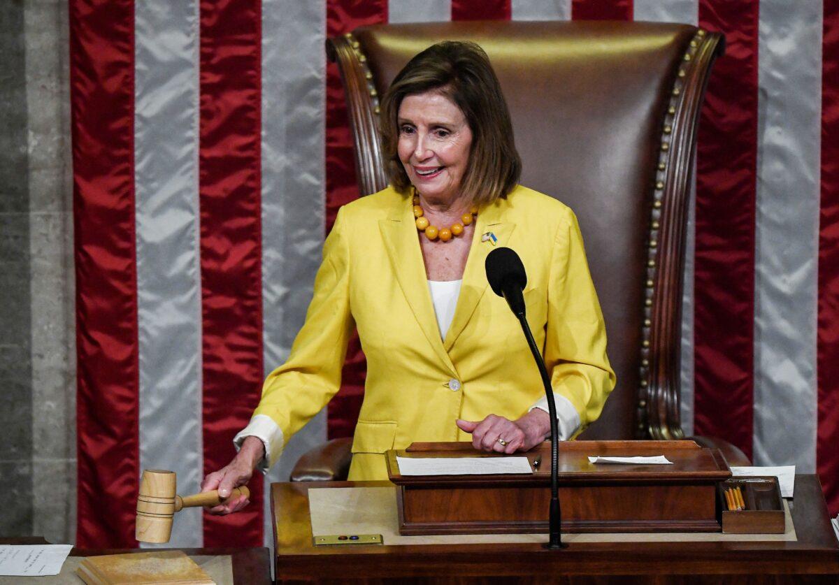 House Speaker Nancy Pelosi (D-Calif.) bangs the gavel after the House of Representatives voted 220–207 to pass the Inflation Reduction Act at the U.S. Capitol in Washington on Aug. 12, 2022. (Olivier Douliery/AFP via Getty Images)