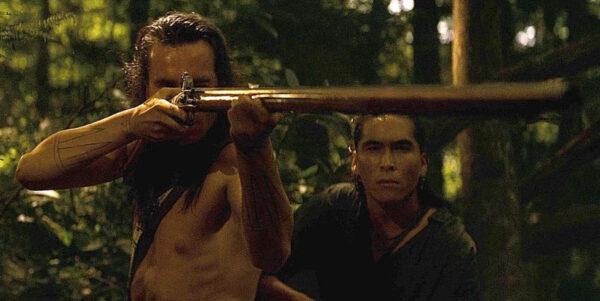Hawkeye (Daniel Day-Lewis, L) showing why he’s so named to adoptive brother Uncas (Eric Schweig), in “The Last of the Mohicans.” (20th Century Fox)