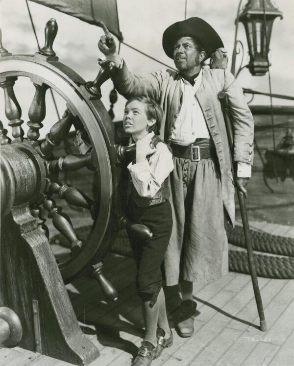 Bobby Driscoll as Jim Hawkins, the adventurous boy who saves the day, and Robert Newton as Long John Silver, the sly villain. RKO Radio Pictures, Walt Disney Pictures. (MoviestillDB)