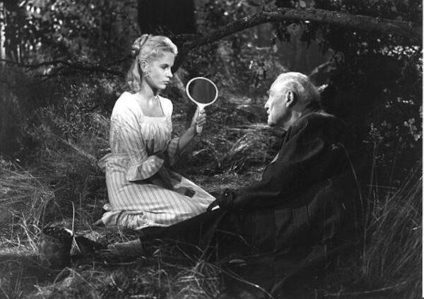 In a dream sequence, Bibi Andersson as young Sara holds a mirror up to Victor David Sjostrom as Isak Borg to show him the poverty of his life in a scene from "Wild Strawberries." (Criterion Collection)
