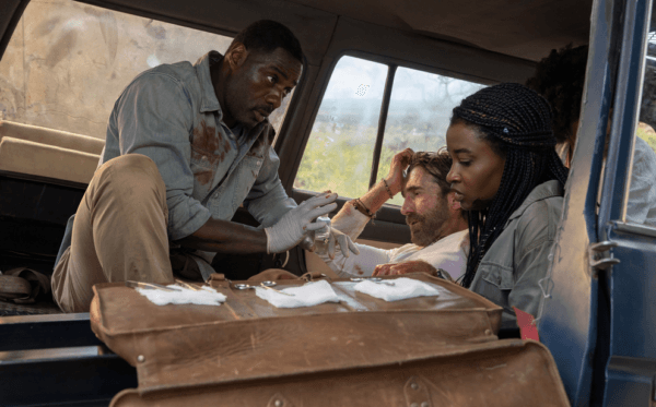 (L–R) Idris Elba (L), Sharlto Copley, and Iyana Halley after an attack in "Beast." (Universal)