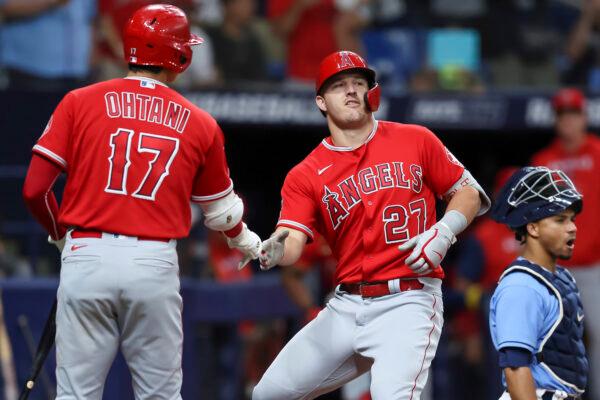 Los Angeles Angels' Shohei Ohtani (17) congratulates Mike Trout in front of Tampa Bay Rays catcher Francisco Mejia after his home run during the eighth inning of a baseball game n St. Petersburg, Fla., Aug. 24, 2022. (Mike Carlson/AP Photo)