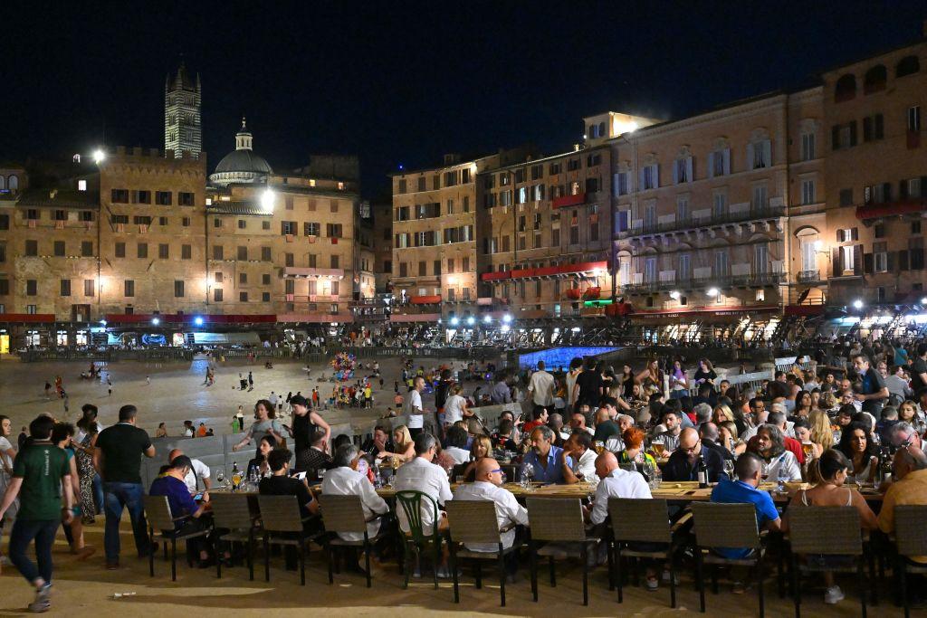 A traditional banquet takes place at Piazza del Campo on the eve of the famous horse race, on July 1, 2022, in Siena, Tuscany. (ALBERTO PIZZOLI/AFP via Getty Images)