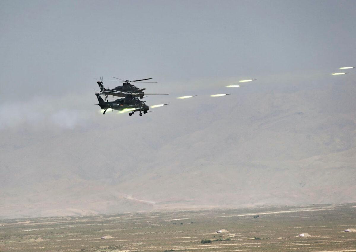 Chinese military helicopter gunships fire rockets during joint war games held by Russia and China in northwestern China on Aug. 13, 2021. (Savitskiy Vadim/Russian Defense Ministry Press Service via AP)
