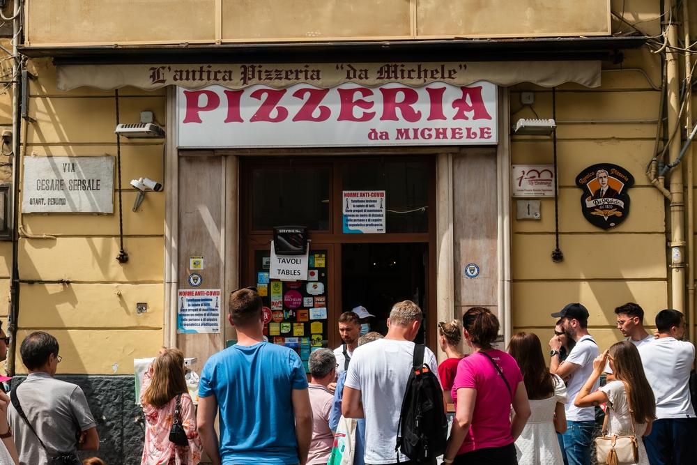 People wait outside the famous L'Antica Pizzeria da Michele in Naples, Italy. (O.Kemppainen/Shutterstock)