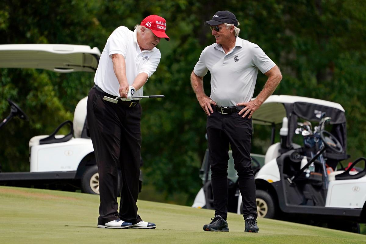 Former President Donald Trump (L) talks with LIV Golf CEO Greg Norman on a green during the pro-am round of the Bedminster Invitational LIV Golf tournament in Bedminster, N.J., on July 28, 2022. (Seth Wenig/AP Photo)