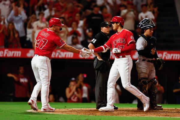Shohei Ohtani (17) of the Los Angeles Angels celebrates with his teammate Mike Trout (27) after hitting a two-run home run against the New York Yankees during the fifth inning at Angel Stadium of Anaheim in Anaheim, Aug. 29, 2022. (Michael Owens/Getty Images)
