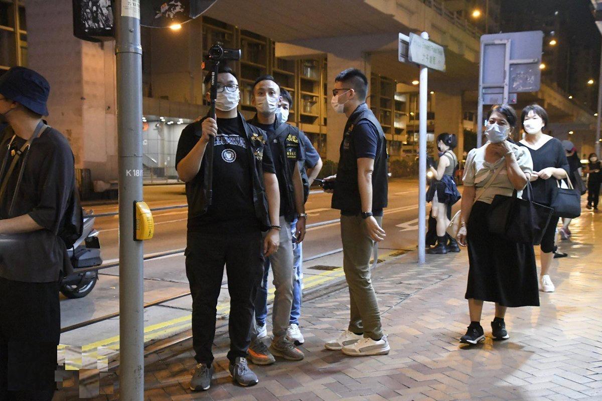 A police officer was recording the public outside Prince Edward MTR Station on Aug. 31, 2022. (Big Mack/The Epoch Times)