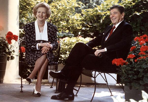 This July 17, 1987, file photo shows former U.S. President Ronald Reagan and former British Prime Minister Margaret Thatcher as they pose for photographers on the patio outside the Oval Office, in Washington, D.C. (Mike Sargent/AFP via Getty Images)