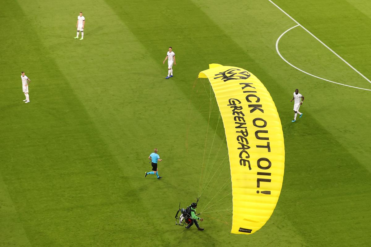 A “Greenpeace” protester is seen flying into the stadium prior to the UEFA Euro 2020 Championship Group F match between France and Germany at Football Arena Munich in Munich, Germany, on June 15, 2021. (Alexander Hassenstein/Getty Images)