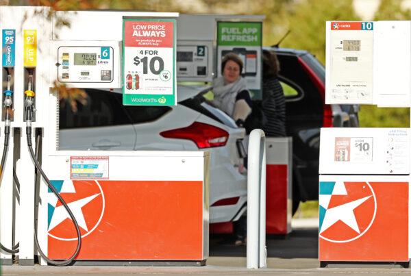 A woman fills her car up with petrol at a Caltex Woolworths petrol station in Melbourne, Australia, on Aug. 10, 2017. (Scott Barbour/Getty Images)