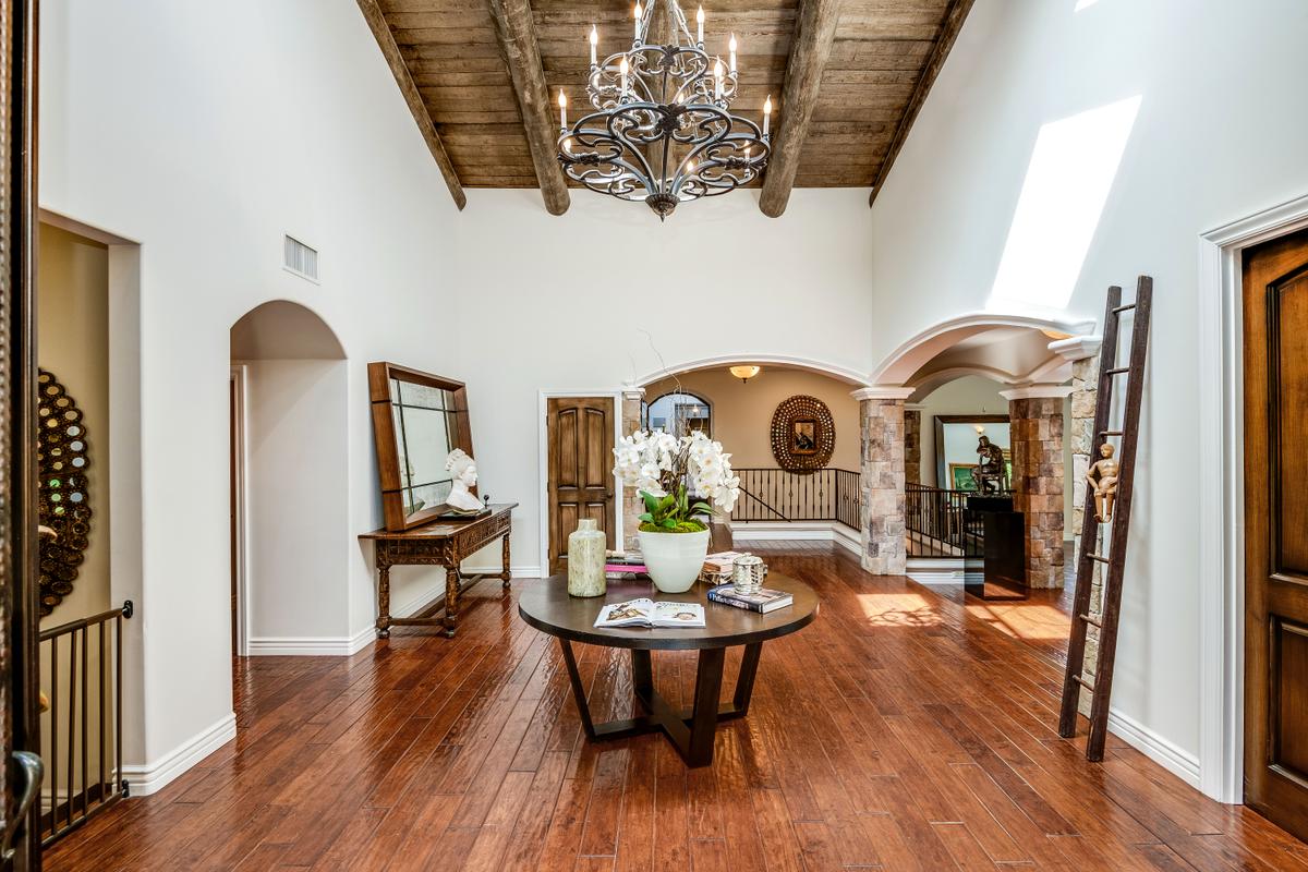 The interior’s magnificent high-beamed ceilings make a remarkable impression. It is accented throughout with curvilinear openings, expansive wall space, and beautiful hardwood floors. (Jade Mills)