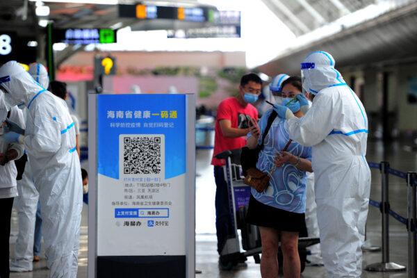A tourist goes through pre-departure formalities at the Sanya Phoenix airport as stranded holidaymakers prepare to leave the COVID-hit resort city of Sanya on Hainan Island on Aug. 9, 2022. (STR/AFP via Getty Images)
