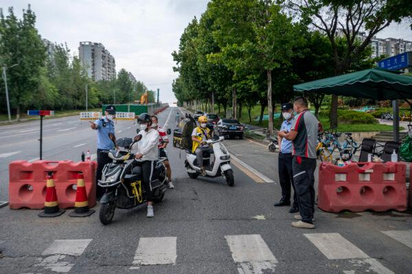 Police officers check people’s information at a roadblock amid restrictions due to an outbreak of COVID-19 in Chengdu, Sichuan Province, China, on Sept. 1, 2022. (CNS/AFP via Getty Images)