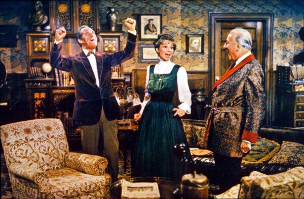 (L–R) Professor Higgins (Rex Harrison) thinks Eliza Doolittle (Audrey Hepburn) has got it, while Higgins's friend Pickering (Wilfrid Hyde-White) cheers her, and they all  sing "The Rain in Spain."  (MovieStillsDB)