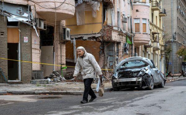 An elderly woman walks past a building partially destroyed by a missile strike in the center of Kharkiv, amid the Russian invasion of Ukraine, on Sept. 13, 2022. (Sergy Bobok/AFP via Getty Images)