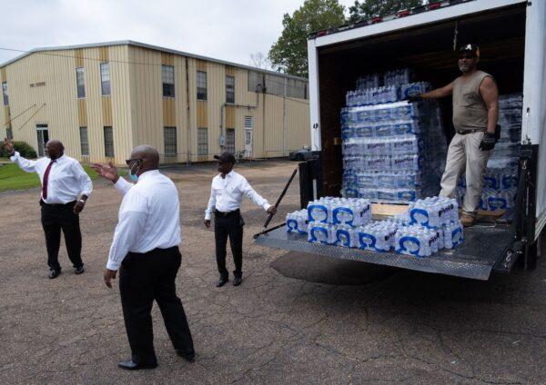 Members of Progressive Morningstar Baptist Church direct people to get bottled water in Jackson, Miss., on Sept. 4, 2022. (Seth Herald/AFP via Getty Images)