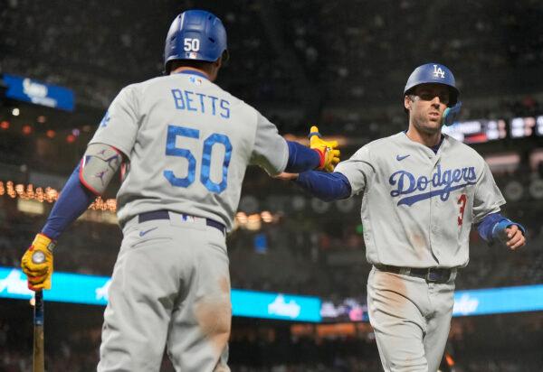 Chris Taylor (3) of the Los Angeles Dodgers is congratulated by Mookie Betts (50) after Taylor scored in the top of the fourth inning against the San Francisco Giants at Oracle Park in San Francisco, on Sept. 16, 2022. (Thearon W. Henderson/Getty Images)