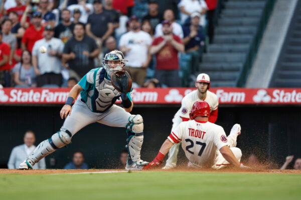 Mike Trout (27) of the Los Angeles Angels slides into home safely off of a double from Shohei Ohtani (17) against the Seattle Mariners during the first inning at Angel Stadium of Anaheim in Anaheim, Calif., on September 17, 2022. (Michael Owens/Getty Images)