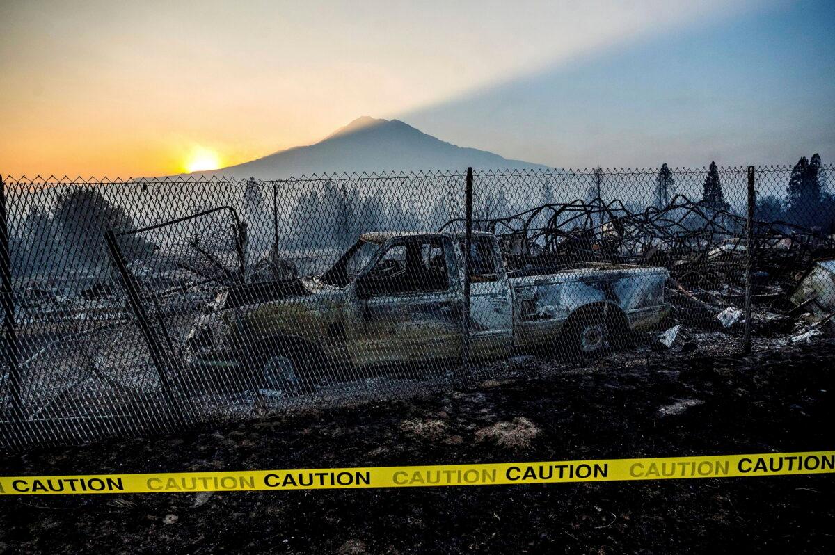 The sun rises over Mt. Shasta and homes destroyed by the Mill Fire in Weed, Calif., on Sept. 3, 2022. (Noah Berger/AP Photo)