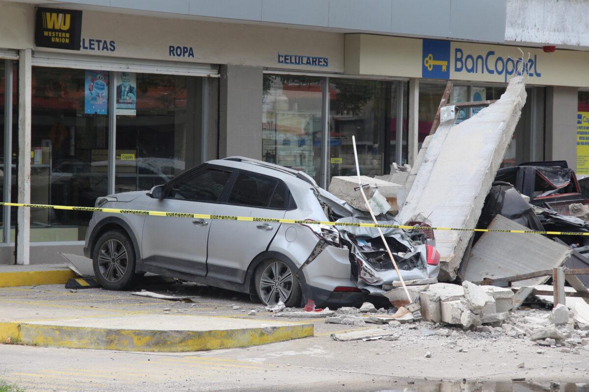 Vehicles damaged by the collapse of the facade of a department store during an earthquake in Manzanillo, Mexico, on Sept. 19, 2022. (Jesus Lozoya/Reuters)