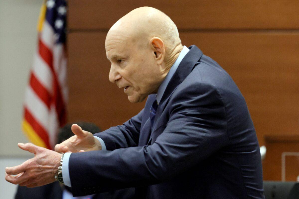 Assistant State Attorney Mike Satz gestures as if he is holding a rifle while giving his closing argument in the penalty phase of the trial of Marjory Stoneman Douglas High School shooter Nikolas Cruz at the Broward County Courthouse in Fort Lauderdale, Fla., on Oct. 11, 2022. (Amy Beth Bennett/South Florida Sun Sentinel via AP)