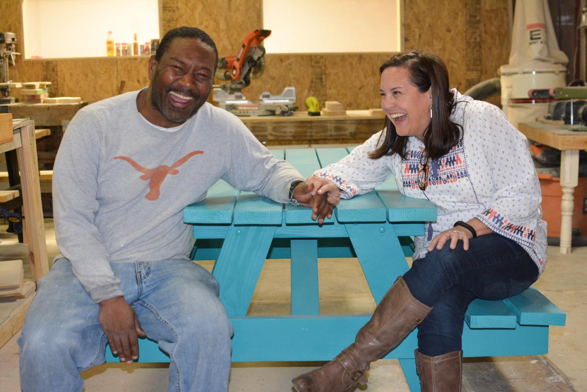 Kristin Schell with an employee of Austin's ReWork Project, a jobs program that employs men and women transitioning out of homelessness to build wooden picnic tables. (Courtesy of Kristin Schell)