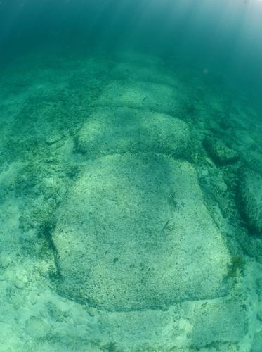 Stones submerged off the coast of the Bahamas, said by some to be a man-made wall, more than 10,000 years old. (FtLaud/Shutterstock)