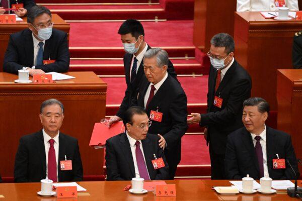 China's President Xi Jinping (R) watches as former president Hu Jintao (C) touches the shoulder of Premier Li Keqiang (2nd L) as he leaves the closing ceremony of the 20th Chinese Communist Party's Congress at the Great Hall of the People in Beijing on Oct. 22, 2022. (Noel Celis/AFP via Getty Images)